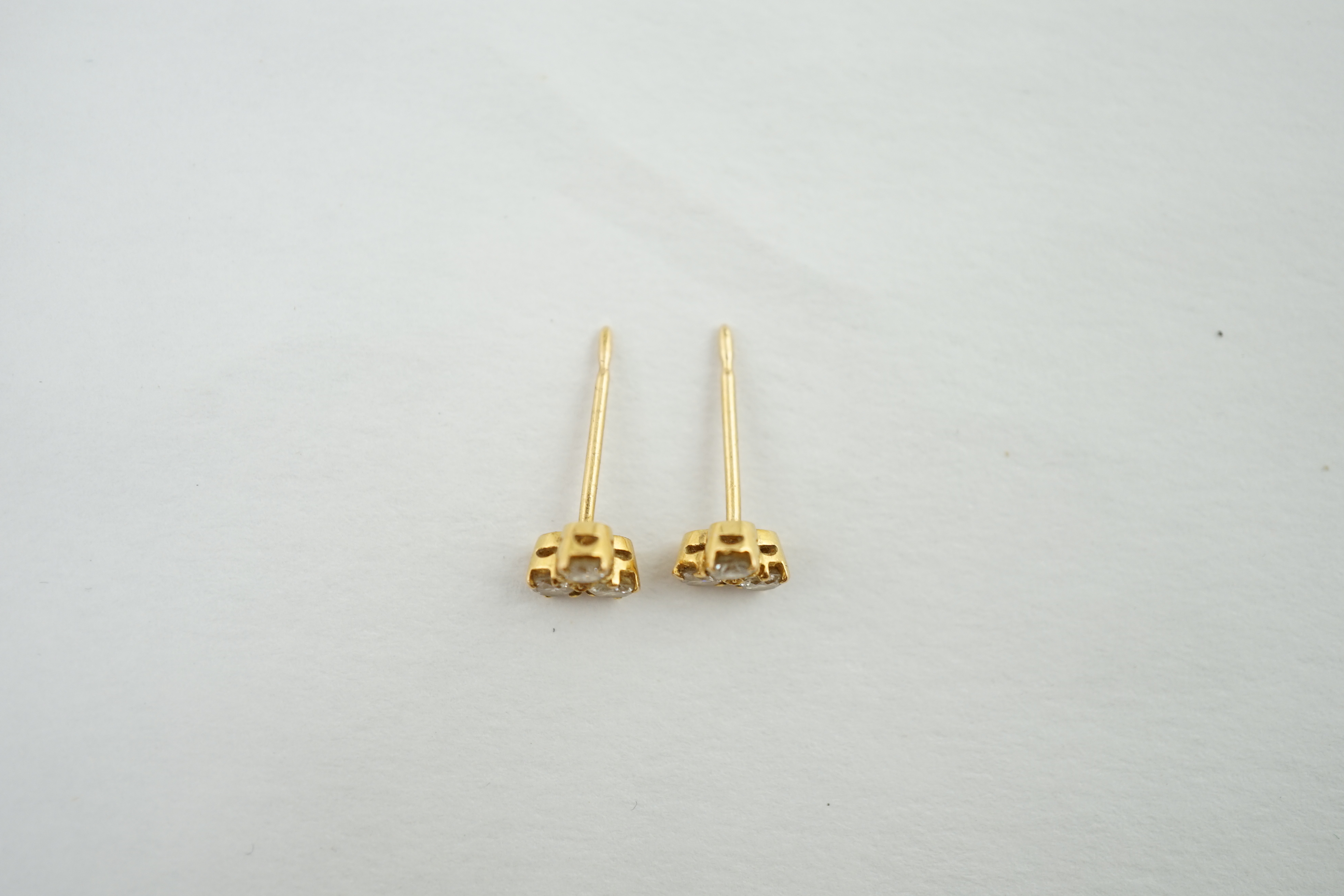 A pair of yellow metal and diamond ear studs